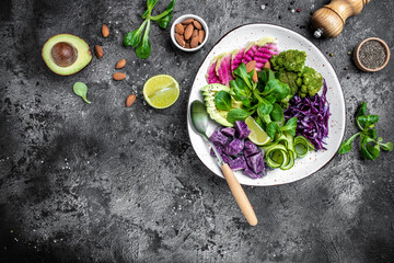 Wall Mural - Healthy vegetarian bowl vegan salad with sweet potatoes, broccoli, avocado, purple cabbage, cucumber, watermelon radish and almonds. Clean eating, dieting food concept. top view