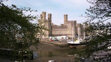 Caernarfon Castle. Drone Pano Shot Behind Trees To The View Of The Castle.