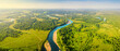 Aerial top view of a peaceful river valley among green plain. Summer scene and eco environment.