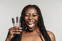 Shirtless Black Woman Laughing While Posing With Lip Glosses