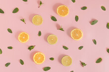 Summer Pattern Made Of Lemon And Lime Slices, And Mint Leaves On Bright Pink Background. Minimal Refreshment Idea. Flat Lay Aesthetic.