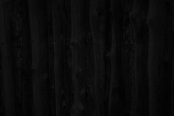 Wall Mural - Black rustic background. Old rough wooden fence surface. Close-up. Dark wood plank background with space for design.