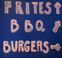 Hand Written Sign Advertising French Fries, BBQ And Burgers