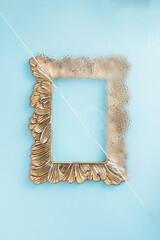 Wall Mural - Retro picture frame partly under steamed glass on a blue background. Minimal flat lay concept.