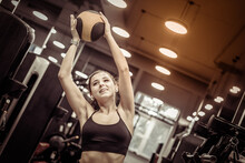 Sport Woman Exercising With Medicine Ball In Hands In Gym