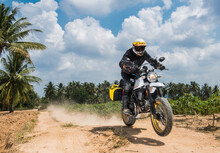 Man Riding His Scrambler Type Motorcycle Off Road In Thailand