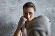 Portrait of Caucasian young woman training boxing jab punch looking at camera
