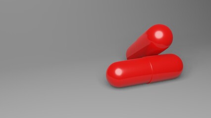 Two red smooth pills lie on a gray background. One pill lies on the other.