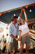 © luckybusiness - Young couple on vacation with the camper.Friends having fun outdoors