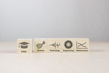 Scientific symbols on wooden building blocks with words. One block pulled slightly forward. Five wood blocks on white background. Education of the sciences and math in pictures and letters.