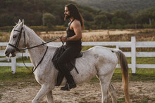 Handsome Muscular Man Riding Horse. Man Ride Horse On Farm. Young Jockey Training His Horse For A Ride.