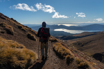 hiking northern slope of tongariro alpine crossing, lake rotoaira and lake taupo in the distance.