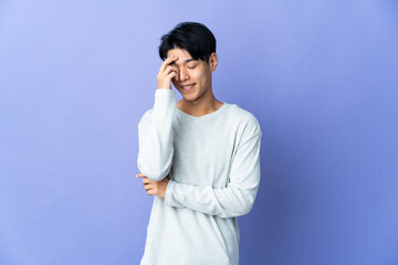 Wall Mural - Young Chinese man isolated on purple background laughing