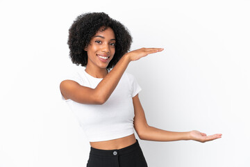 Wall Mural - Young African American woman isolated on white background holding copyspace to insert an ad