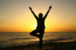 © Monique Pouzet - A yoga posture on the beach, the tree
