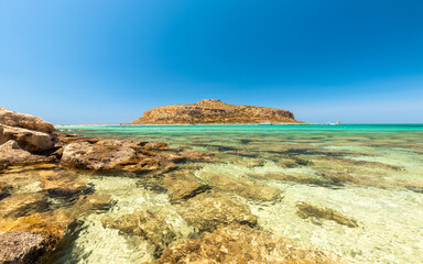 Wall Mural - Paradise beach of Balos in Crete, Greek holiday island landscape, Crystal clear water, charming rocks on the shore