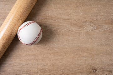 Wall Mural - Close up baseball and baseball bat on wooden table copy space background, sport concept