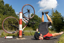 The Unhappy Cyclist Falls Of The Bike Beside The Barrier On A Bicycle Path.