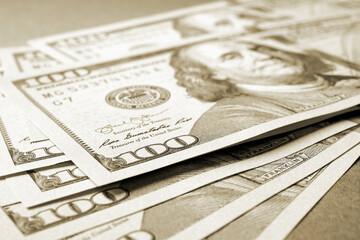 Wall Mural - american paper money. several one hundred dollar bills lie on textured surface. focus on the number 