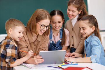 Wall Mural - Teacher and students watching video together