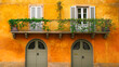 Orange Italian house facade in a typical town of Italy with green doors and balcony with white shutters. Pretty postcard background from Italy.