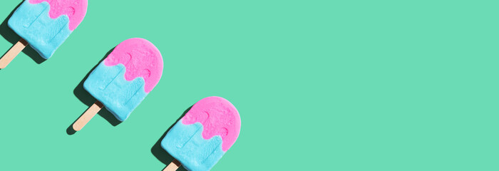 Wall Mural - Pink and blue popsicles with shadow - flat lay