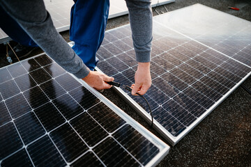 Wall Mural - Worker installing solar energy panels. connect two panel together. eco concept