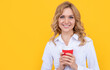 © Olena - cheerful blond woman with coffee cup on yellow background