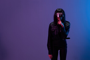 Wall Mural - Cool offer. Awesome brunet woman in leather jacket trendy specular sunglasses finger near mouth Shh posing isolated in blue violet color light background. Neon party Cyberpunk concept. Copy space