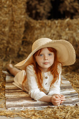 Wall Mural - Little girl and cute ducklings are sitting in a basket in the kitchen.