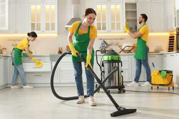 Canvas Print - Team of professional janitors working in kitchen