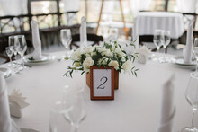 Decorated Wedding Table For Guests With A Number And A Box Of Flowers