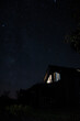 Country house under stary sky at night