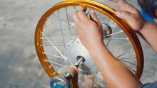 Technician Man Working Motorcycle Wheel Has Spokes Weave Up On Mechanic New Steel Wheel, Motorcycle Spokes Wheel Alignment Machine Tool