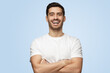 © Damir Khabirov - Young attractive European man with arms crossed shows opened friendly smile