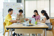 © amnaj - Group Young Asian business people with the creative work, talk and exchange ideas shared at the meeting.