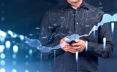 Businessman using smartphone. Stock market graphs, lines and chart