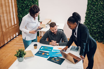 Wall Mural - Multicultural team working together in office and having a meeting