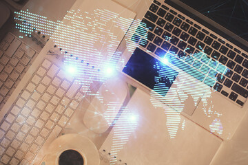 Poster - Social network hologram drawings over computer on the desktop background. Top view. Double exposure.