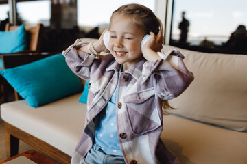 Wall Mural - cute smiling girl listen to the music with headphones