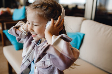 Wall Mural - cute smiling girl listen to the music with headphones