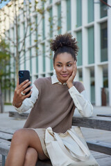 Wall Mural - technology leisure people and free time concept. pretty millennial girl takes selfie on front camera