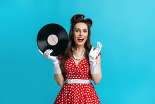 Retro Music, Old Songs, Nostalgia. Excited Young Pinup Woman In Retro Polka Dot Dress Holding Gramophone Vinyl Record