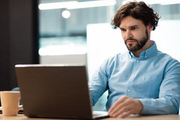 Sticker - Business man using laptop sitting at desk in office