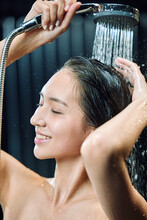 A Happy Young Woman With A Shower
