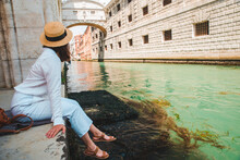 Woman Sitting At City Quay At Venice Italy Enjoying The View Of Canals