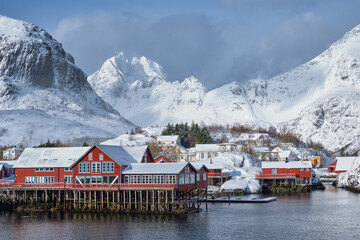 Fototapete - Traditional fishing village A on Lofoten Islands, Norway with red rorbu houses. With snow in winter