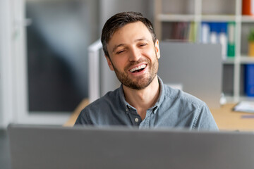 Poster - Portrait of happy mature male manager working on computer, having video call and smiling at screen