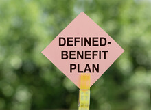 DEFINED-BENEFIT PLAN - Inscription On Pink Road Sign On Blurred Green Background.