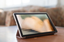 Closeup Of A Young Caucasian Man Watching A Nude Woman In His Tablet Computer